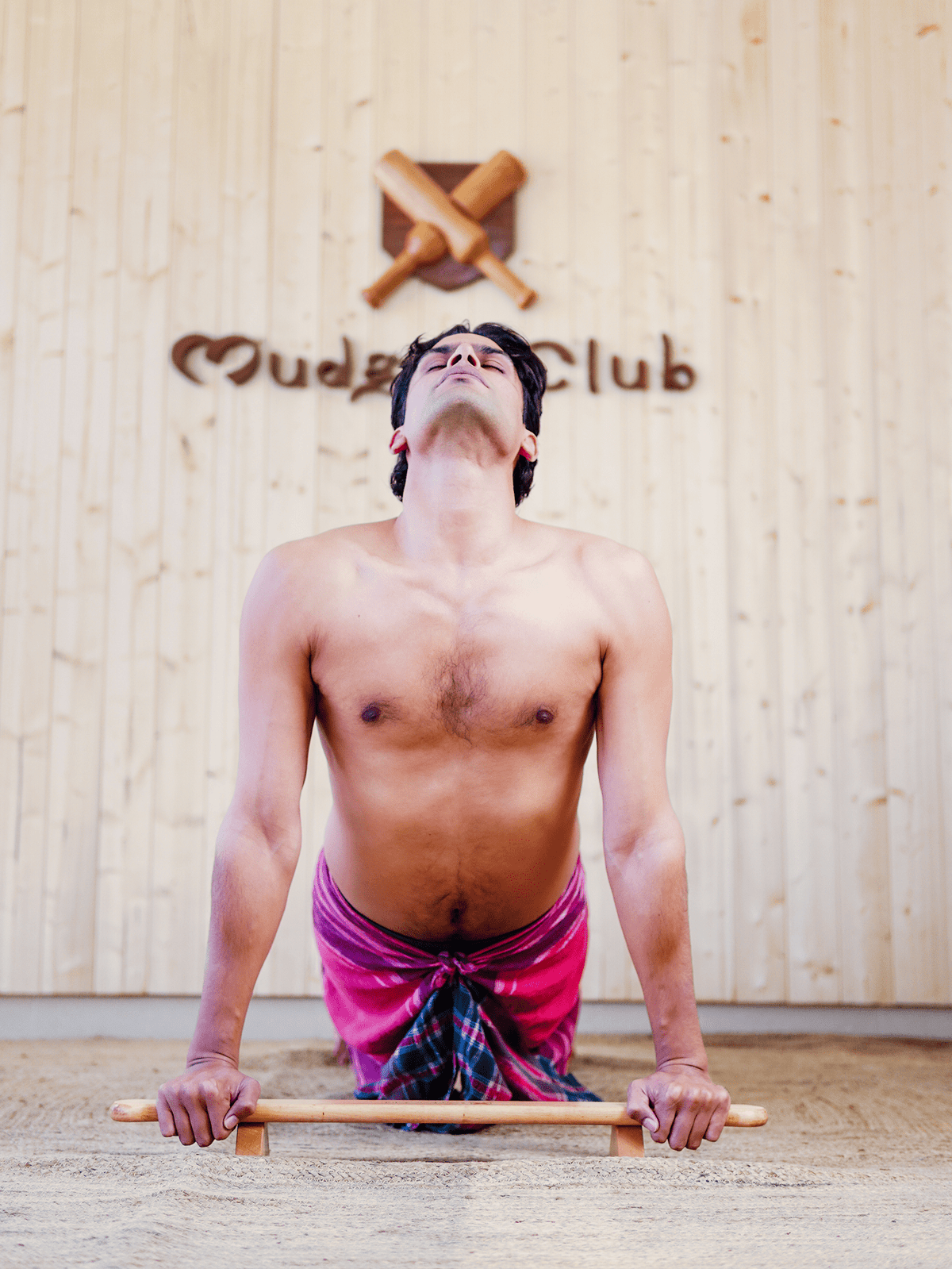 Anjit demonstrating hand placement on the Shena Push-Up Board
