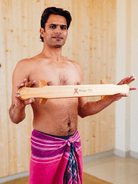 Anjit holding the handcrafted wooden Shena push-up board